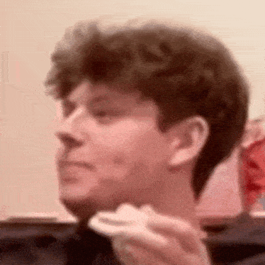 a man is eating a piece of cake in a restaurant .