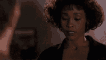 a man and a woman are looking at each other . the woman is wearing earrings .