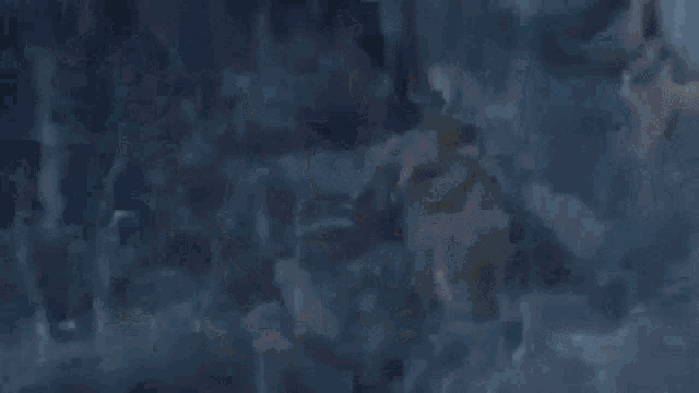 a person in a red cape is flying through the air in the rain .