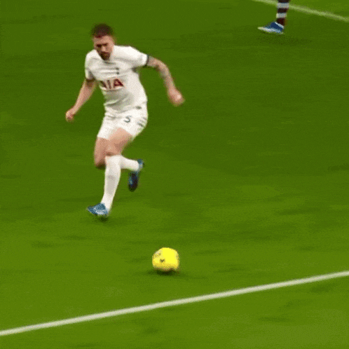 a soccer player with the number 4 on his jersey is laying on the ground