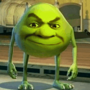 a green cartoon character with a shrek face is standing on a wooden floor in front of a bed .