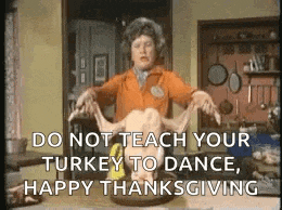 a woman is holding a turkey on a plate with the words `` do not teach your turkey to dance , happy thanksgiving '' .