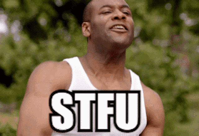 a man wearing a white tank top with the word stfu on it