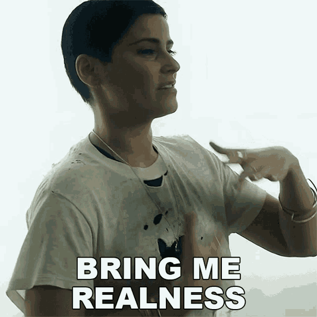 a woman says bring me realness in a white shirt