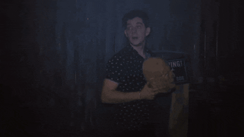 a man holding a piece of paper in a dark room with the words " you did this " above him