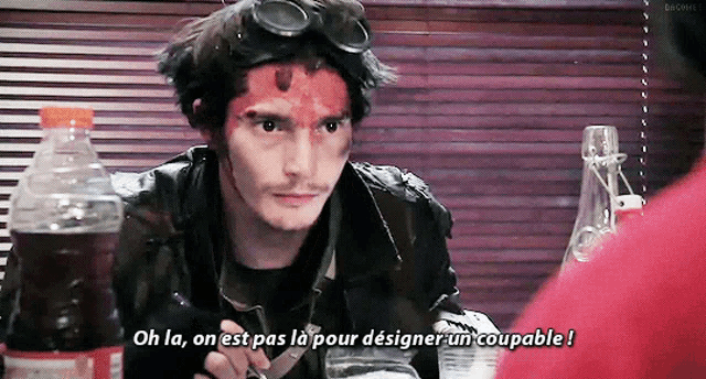a man with red paint on his face says oh la on est pas la pour designer un coupable !