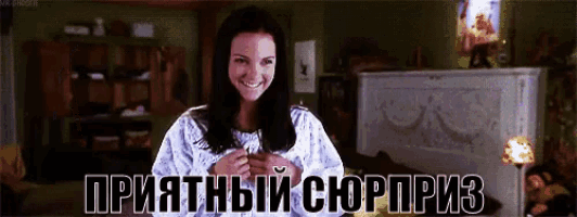a woman is smiling in a room with russian writing