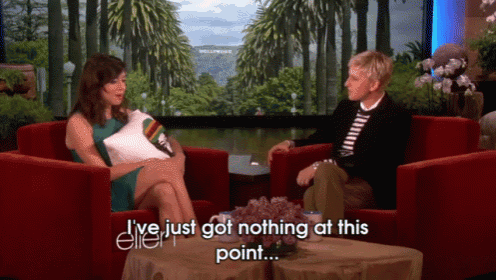 a woman sits in a red chair talking to ellen