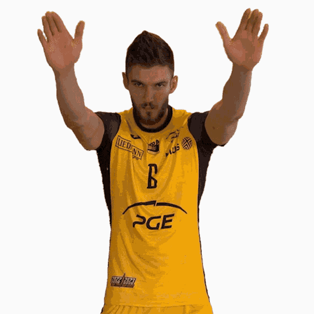 a man wearing a yellow shirt with pge on the front
