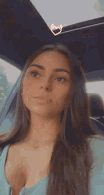 a woman is sitting in the back seat of a car .
