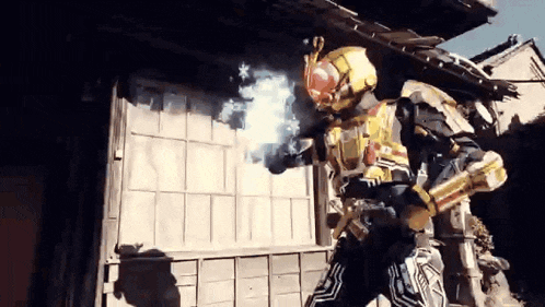 a man in a robot costume is standing in front of a building holding a sword .
