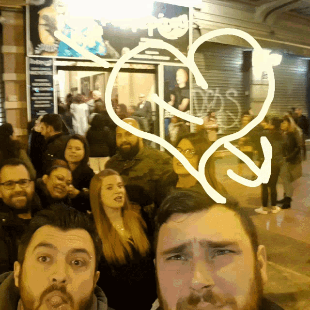 a group of people are posing for a picture in front of a sign that says ' apollo ' on it