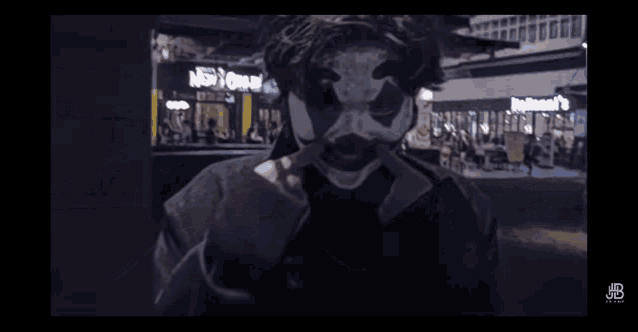 a man in a clown costume is standing in front of a new york city restaurant