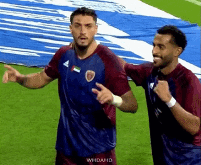 two soccer players on a field with whdahd on the bottom right