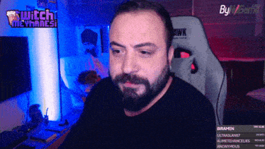 a man with a beard is playing a video game on a twitch channel