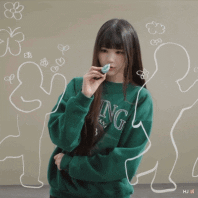a girl in a green sweatshirt that says ing on it