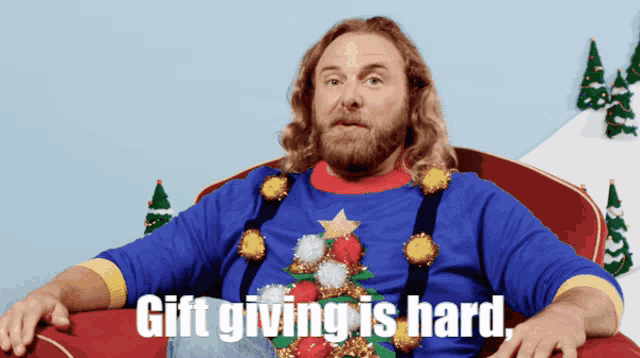 a man in an ugly christmas sweater is sitting in a chair with the words gift giving is hard