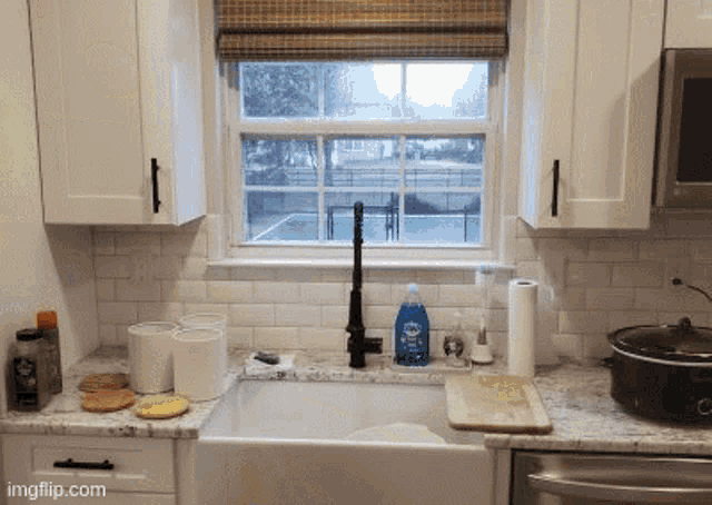 a kitchen with a sink and a window that says ingflip.com