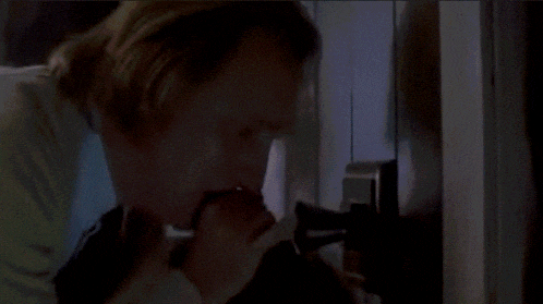 a man in a suit and tie is looking into a refrigerator with the words " one boiled egg " on the bottom