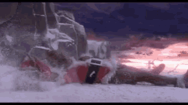 a person in a santa suit is laying on a snowy hill .