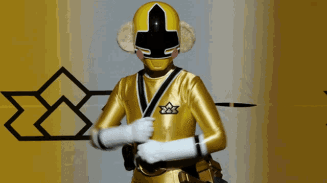 a yellow superhero with a black cross on his head