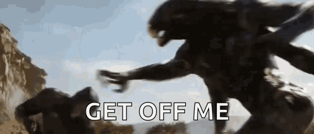 a blurred image of a monster with the words `` get off me '' written in white letters .