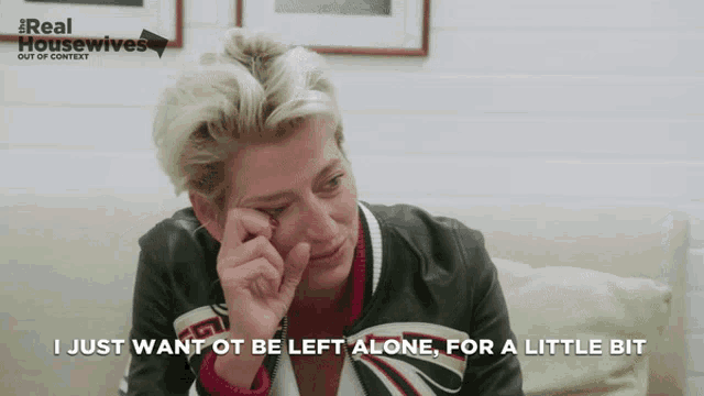 a woman sitting on a couch with the words " i just want ot be left alone for a little bit " above her