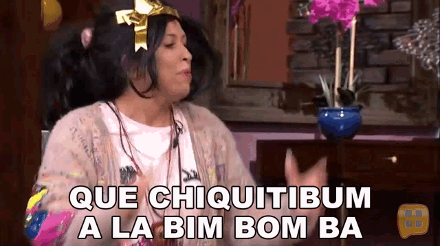 a woman with a bow on her head is saying que chiquitibus a la bim bom ba