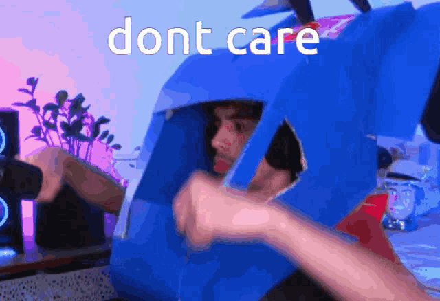 a man in a cardboard robot costume says " dont care " on the bottom