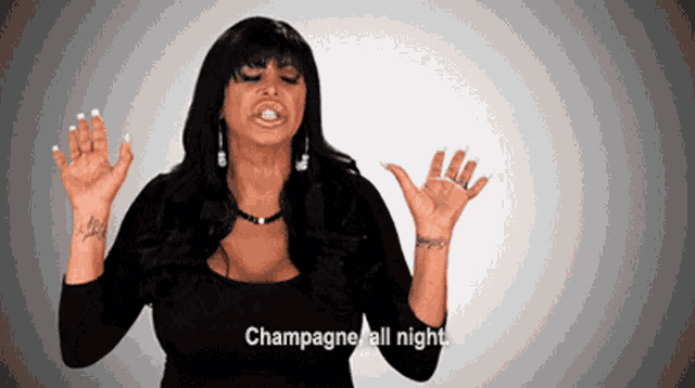 a woman says champagne all night with her hands up in the air