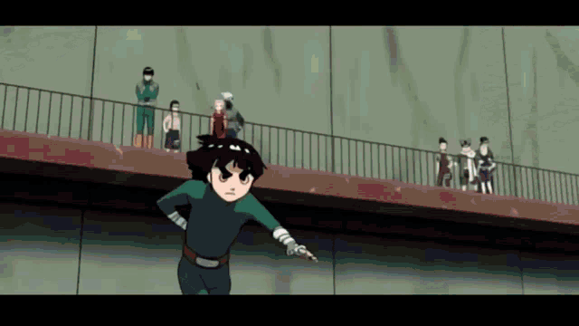 a group of people are standing on a bridge watching a boy in a green outfit