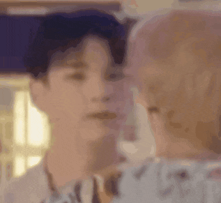 a man and a woman are looking at each other and kissing .