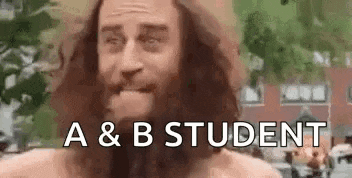 a shirtless man with a beard and long hair is standing in front of a building and says `` a & b student '' .