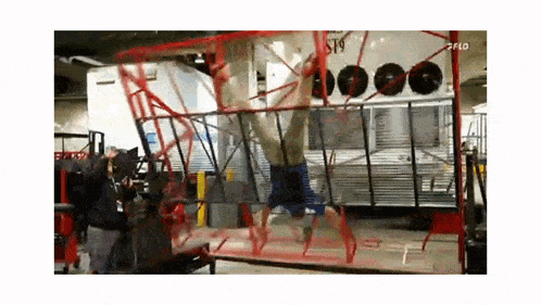 a man is doing a handstand on a ladder in a room .
