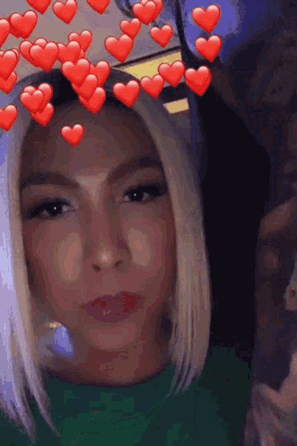 a close up of a woman 's face with hearts on it