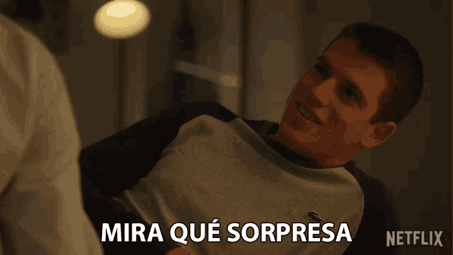 a man is laying down with the words mira que sorpresa written below him