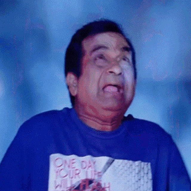 a man wearing a blue shirt that says " one day your life will flash "
