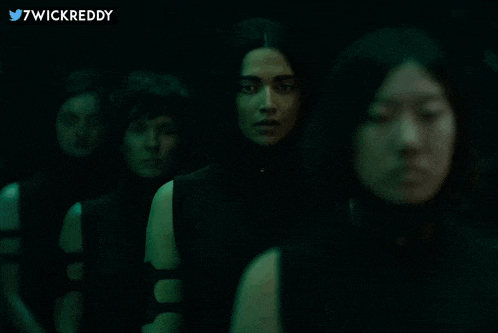 a group of women standing in a dark room with 7wickreddy written in the corner