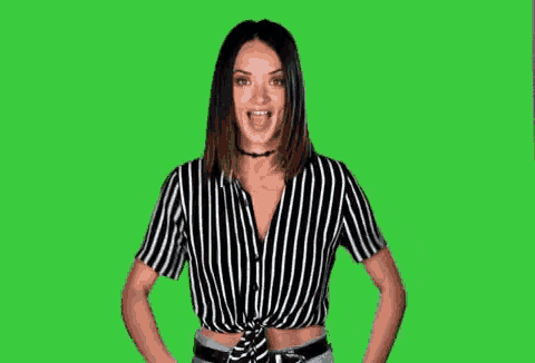 a woman in a black and white striped shirt is giving a thumbs up sign .