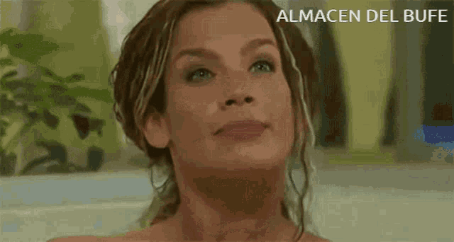 a close up of a woman 's face with almacen del bufe written below her