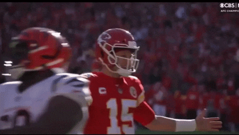 a football player wearing a helmet with the number 15 on it is standing on the field .