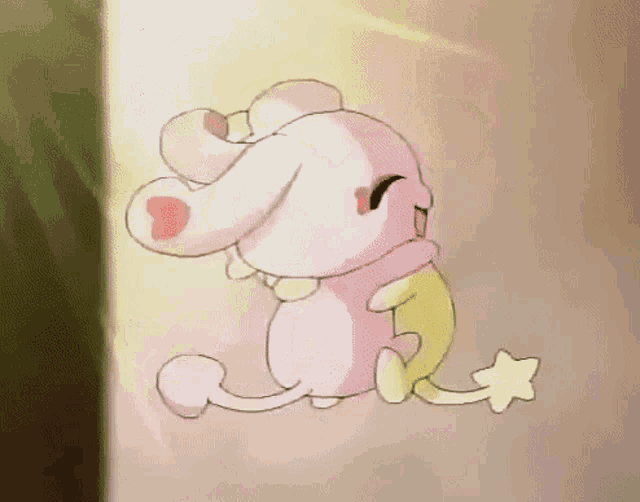 a pink and yellow cartoon rabbit with a star on its tail is sitting on a wall .