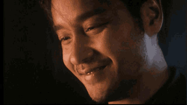 a close up of a man 's face with a black background