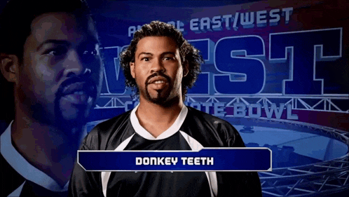 a man with the name donkey teeth in front of a sign that says east west