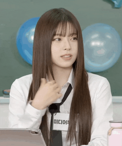 a girl in a white shirt and tie has a name tag that says dicie