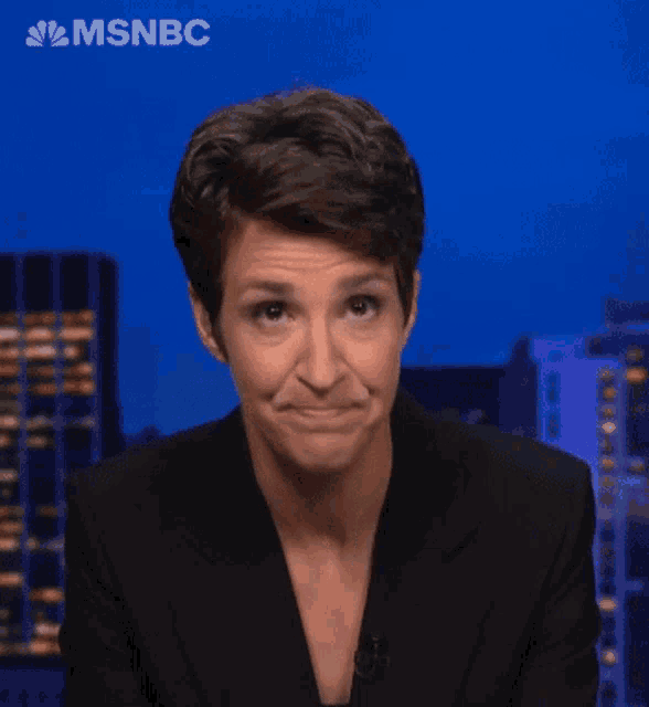 a woman in a black suit is on msnbc
