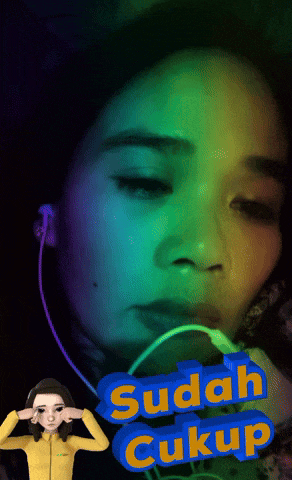 a woman wearing headphones and a sign that says sudah cukup on it