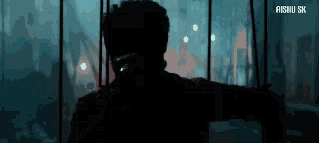 a silhouette of a man talking on a cell phone with the words aishu sk written on the bottom