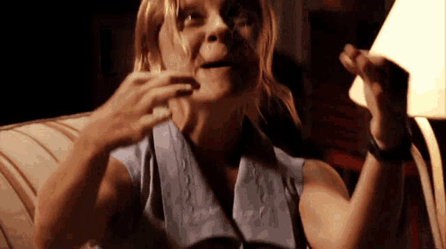 a woman with a towel around her neck is making a face