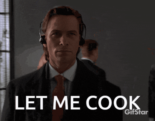 a man in a suit and tie with headphones on says let me cook